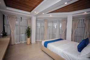 A modern bedroom with a large bed, a coffee machine, and a potted plant. - Hotel Melung (Kathmandu)