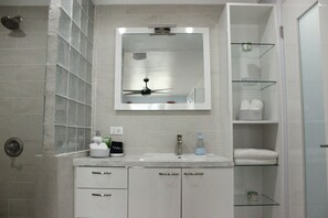 A bathroom with a shower, a mirror, a ceiling fan, and a sink. - Casa Iliria 3: Fantastic Studio Within Walking Distance of Boqueron Beach (Boquerón)