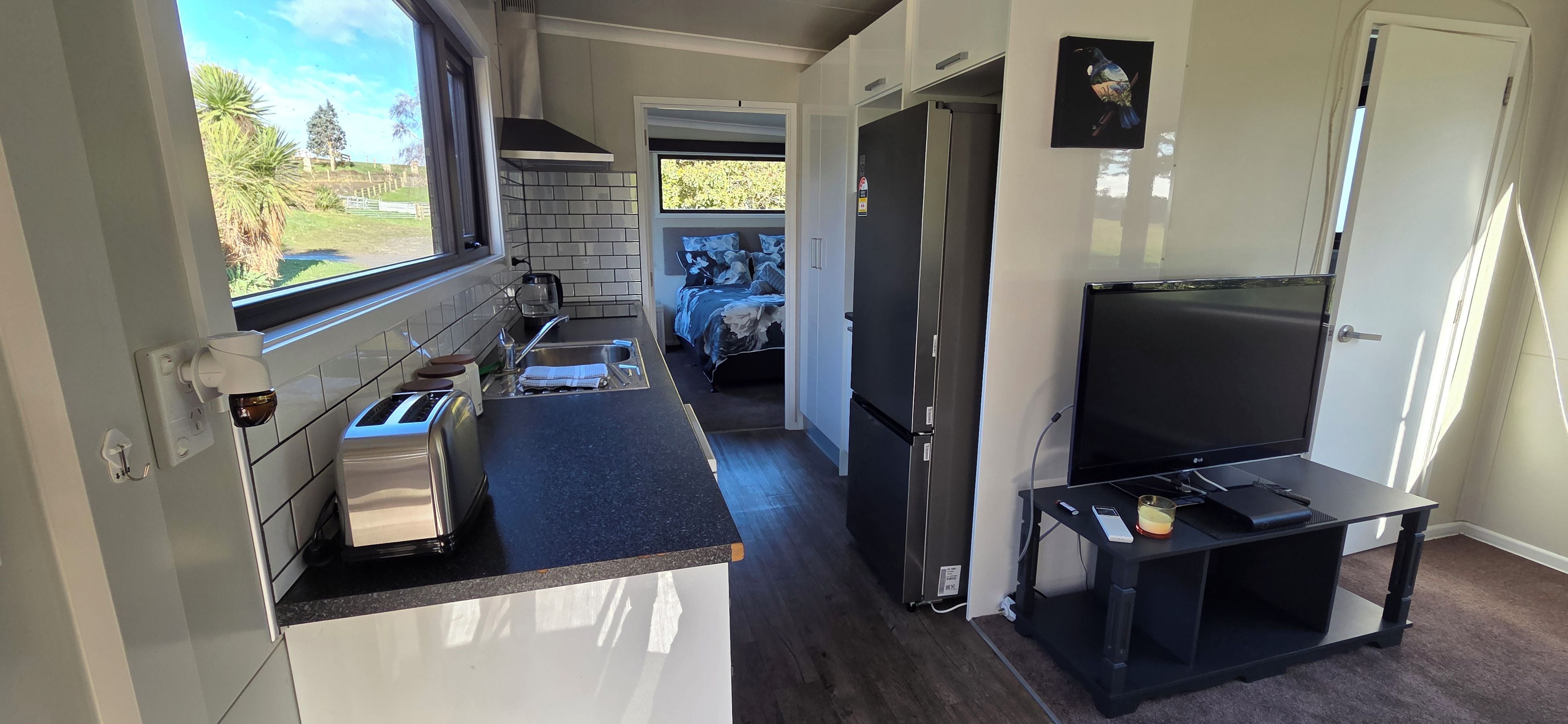 Well appointed kitchen with full size fridge/freezer and induction cooktop
