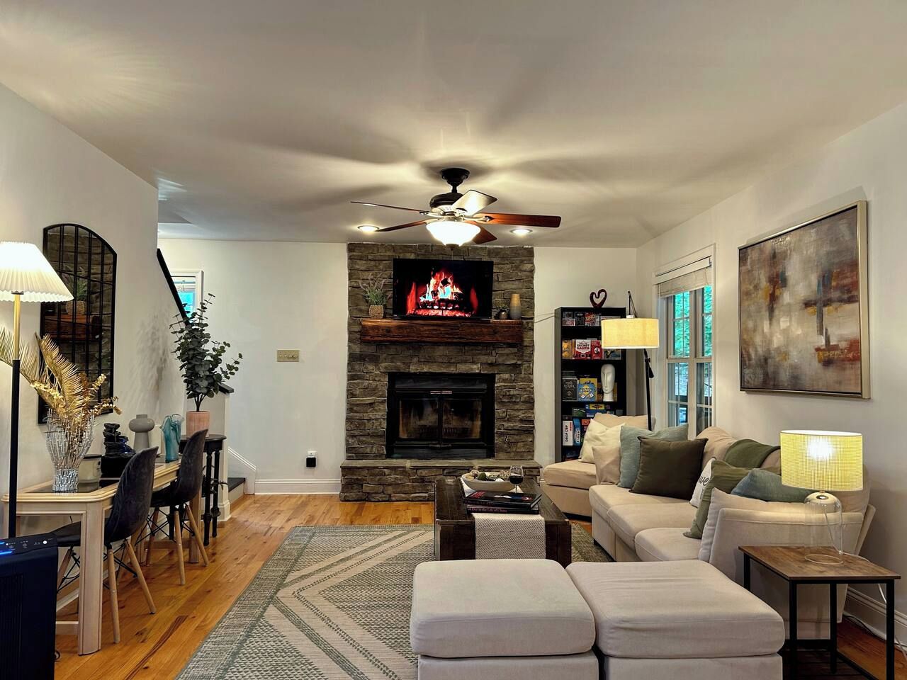A living room with a fireplace, a dining area, and a sofa set.