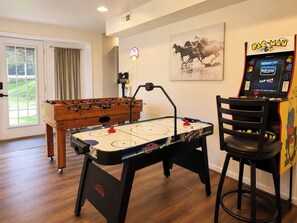 A room with a foosball table, a table tennis table, and a Pac-Man arcade game. - The RidgeView Retreat-HotTub Sauna Forest Patio (Harpers Ferry)