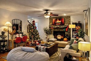 A cozy living room with a fireplace, a Christmas tree, and a comfortable seating area. - The RidgeView Retreat-HotTub Sauna Forest Patio (Harpers Ferry)