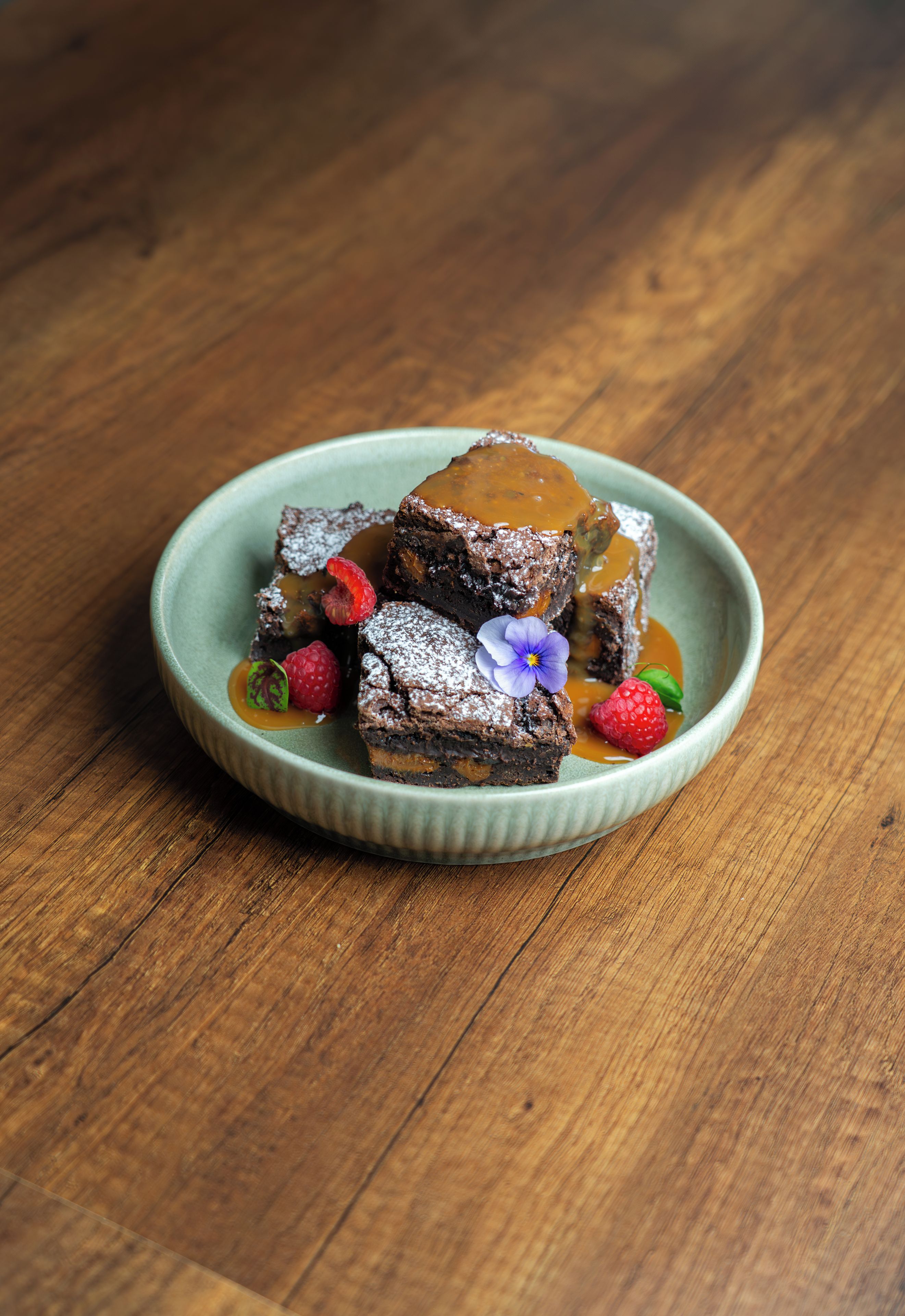A dessert on a ceramic plate with a wooden table background.