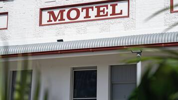 A building with a sign that reads 'MOTEL' above the entrance.