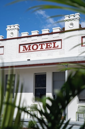 A building with a sign that reads 'MOTEL' above the entrance.