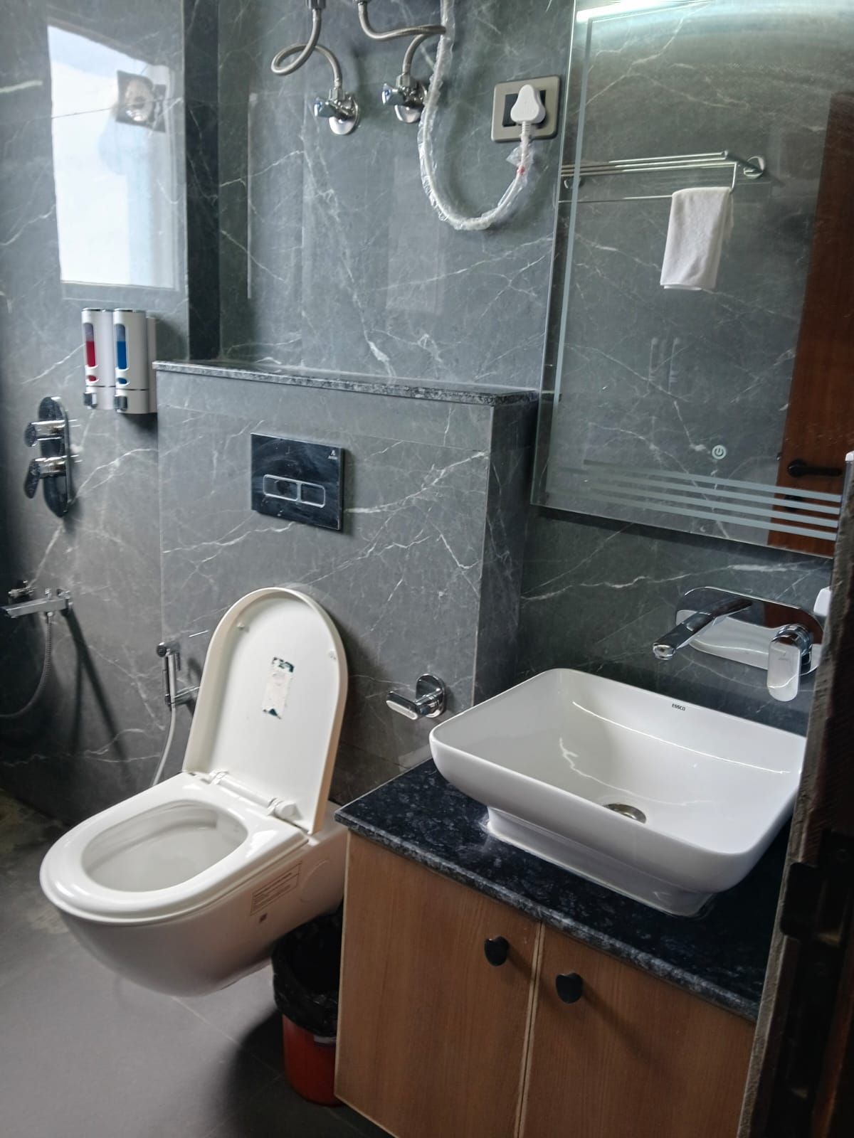 A bathroom with a toilet, sink, and shower.