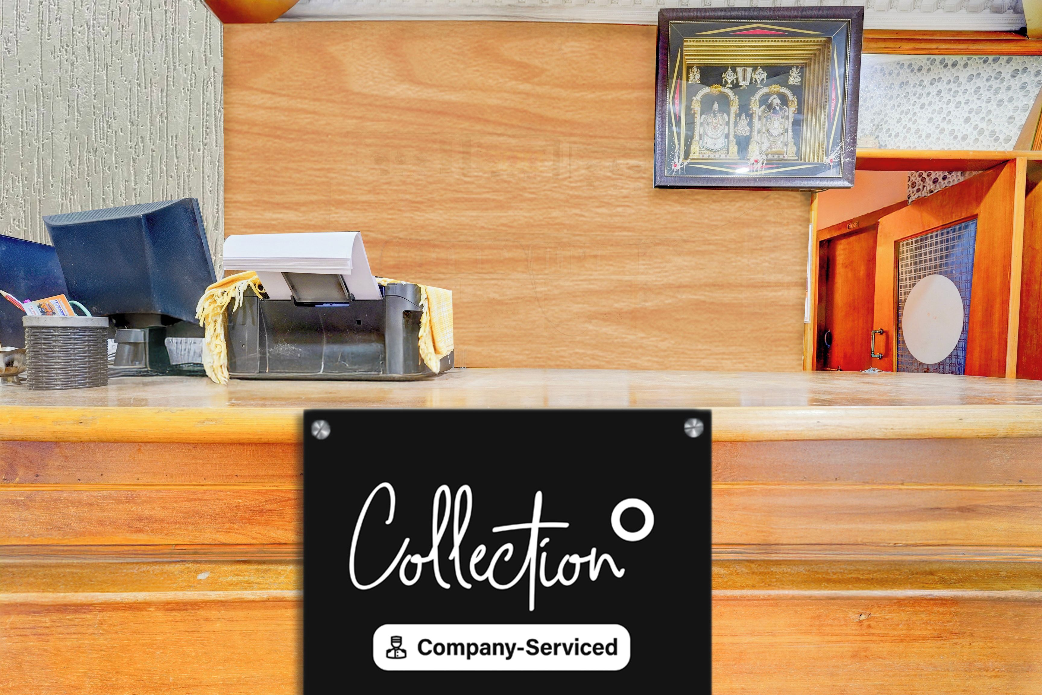 A reception desk with a sign that reads 'Collection & Company-Serviced.'