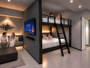Een modern interieur met een stapelbed, een flatscreen televisie, een bank en een salontafel.