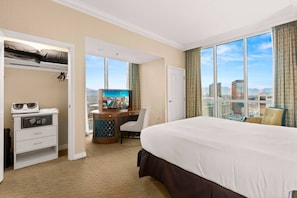 A hotel room with a large bed, a desk with a television, a wardrobe, and a city view. - 38 Floors Above Vegas | Epic Strip Views (Las Vegas)