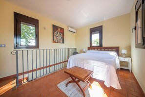A bedroom with a bed, a nightstand, a window, and a painting on the wall. - Boutique Villa Marcia—Adults Only, 10 minutes from the beach. (Altafulla)