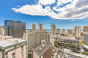 A high-rise hotel with multiple floors, a parking garage, and a view of the ocean. - Prime Waikiki 1BR | Free Parking, Pool & W/D (Honolulu)