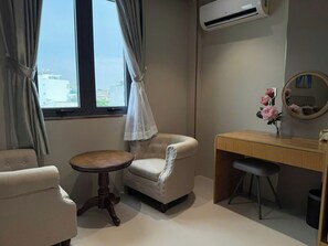 A room with a bed, a desk, a chair, and a window with curtains. - Leonora 3 (Ho Chi Minh Municipality)