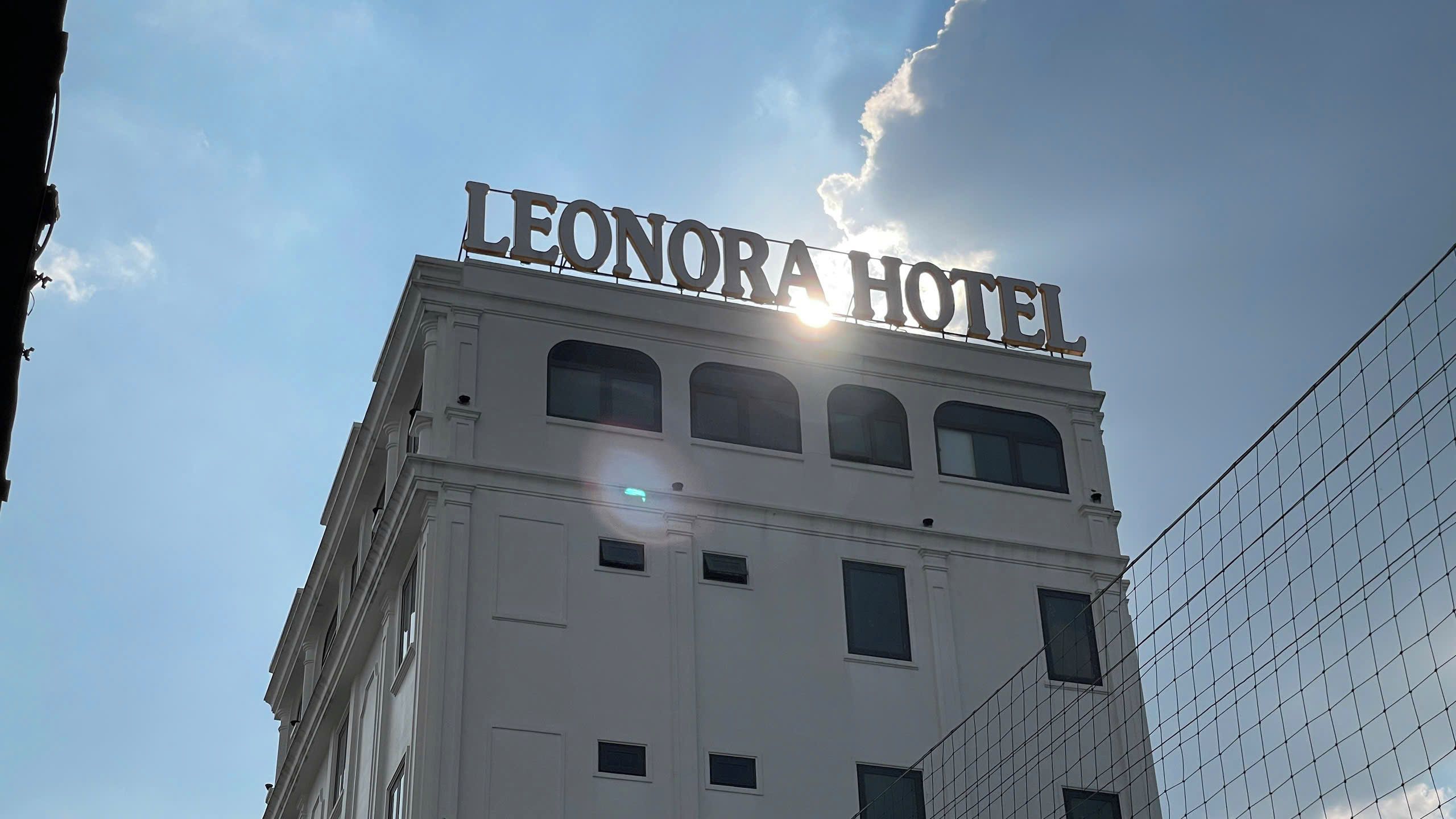 La façade de l’hôtel Leonora, avec un ciel dégagé et ensoleillé.