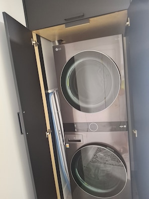 An open wardrobe with two circular mirrors and a hanging rack. - Brand new 2 bed room 1private washroom (Delta)
