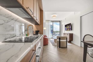 Eine moderne Küche mit Marmorarbeitsplatte, Edelstahlgeräten und Holzausstattung.