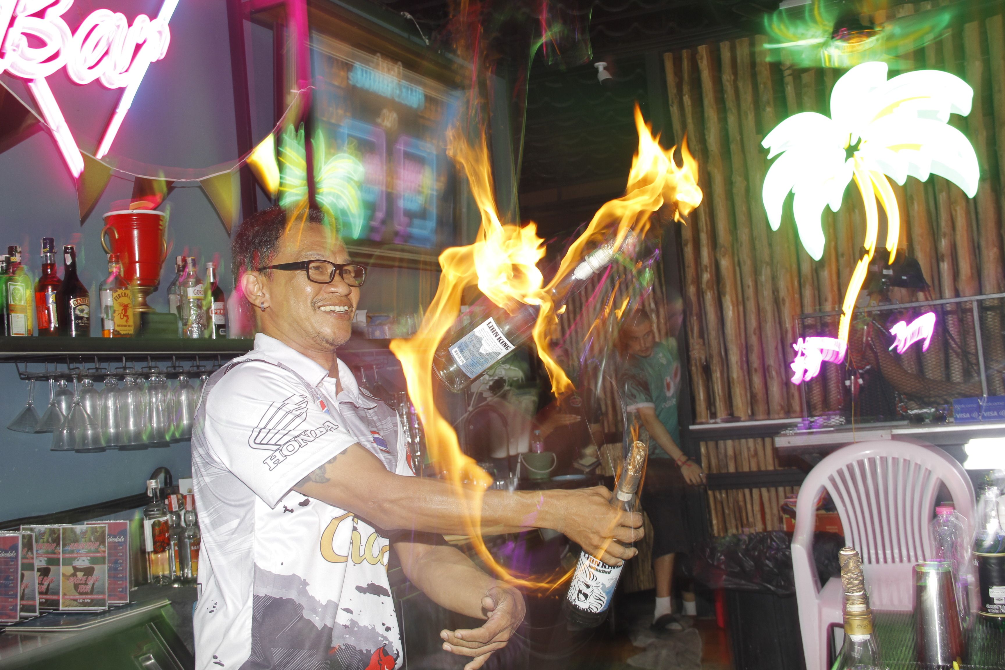 A person pouring a bottle with a flaming effect.