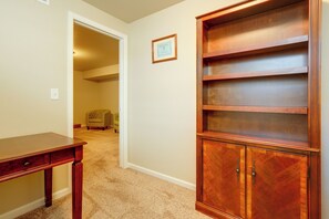 A room with a wooden cabinet, a desk, and a framed certificate on the wall. - Family-Friendly Home! Walk to Windsor Lake (Windsor)
