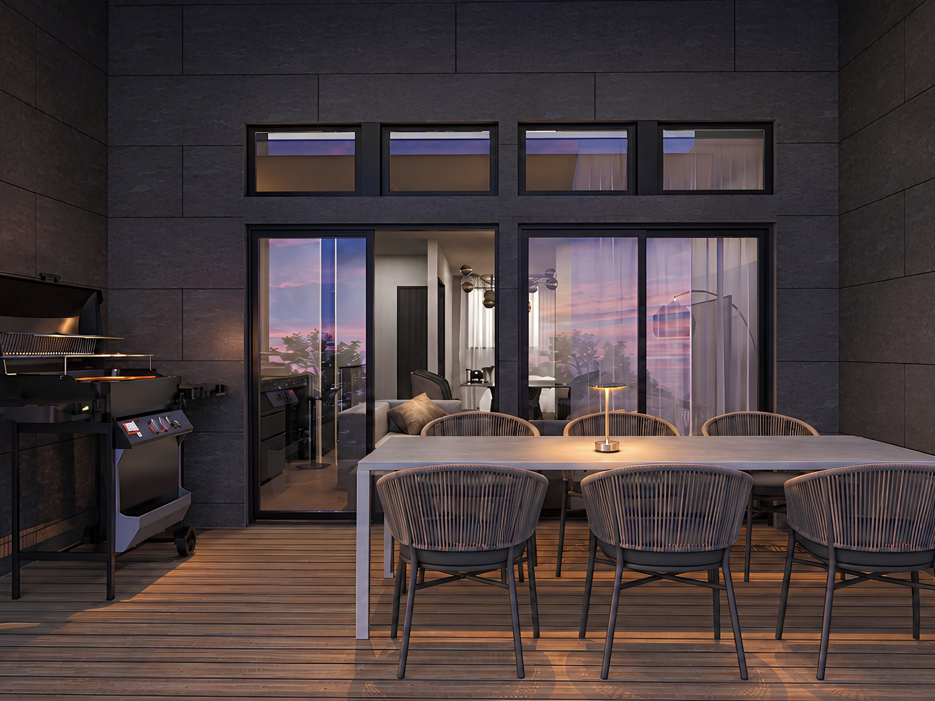 Un espacio exterior moderno para comer con una parrilla, puertas correderas de vidrio y vistas a la ciudad.
