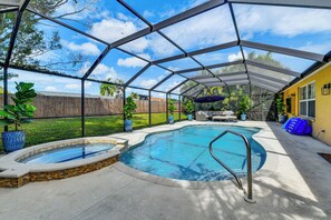 A covered backyard with a swimming pool, a hot tub, and outdoor furniture. - Extended Retreat Near Buffalo Creek Golf Course! (Palmetto)
