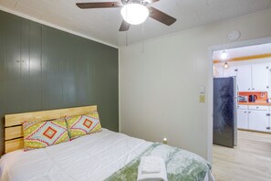 A bedroom with a bed, a ceiling fan, and a view into the kitchen. - Creekside Haven 5 Mi to Dtwn Boone! Bring Your Pup (Boone)