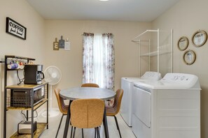 A compact kitchen with a dining table, chairs, a coffee machine, and a washing machine. - 5 Mi to Dtwn & Bricktown! Quaint Escape (Oklahoma City)
