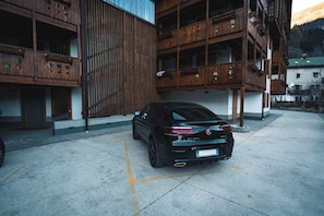 A black car parked in a building's parking area. - Borgo Nuovo Deluxe con Disney+, 2 Parcheggi (Forni di Sopra)