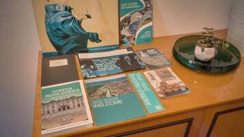 A table with various travel brochures and a potted plant.