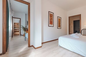Ein Hotelzimmer mit Bett, Spiegel und einem Gang zum Badezimmer.