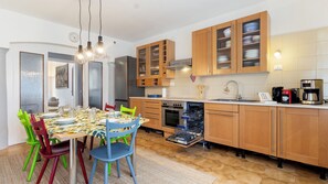 A modern kitchen with wooden cabinets, a dishwasher, and a coffee maker.