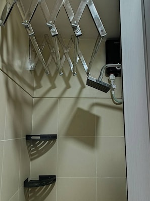 A shower area with a metal shower head and a control panel. - Modern, Comfortable Apartment in Central Pasay, Philippines (Pasay)