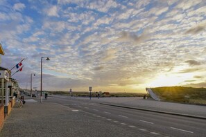 A coastal road with a clear sky, a flag, and a sunset. - Holiday apartment with 1 bedroom (Katwijk aan Zee)