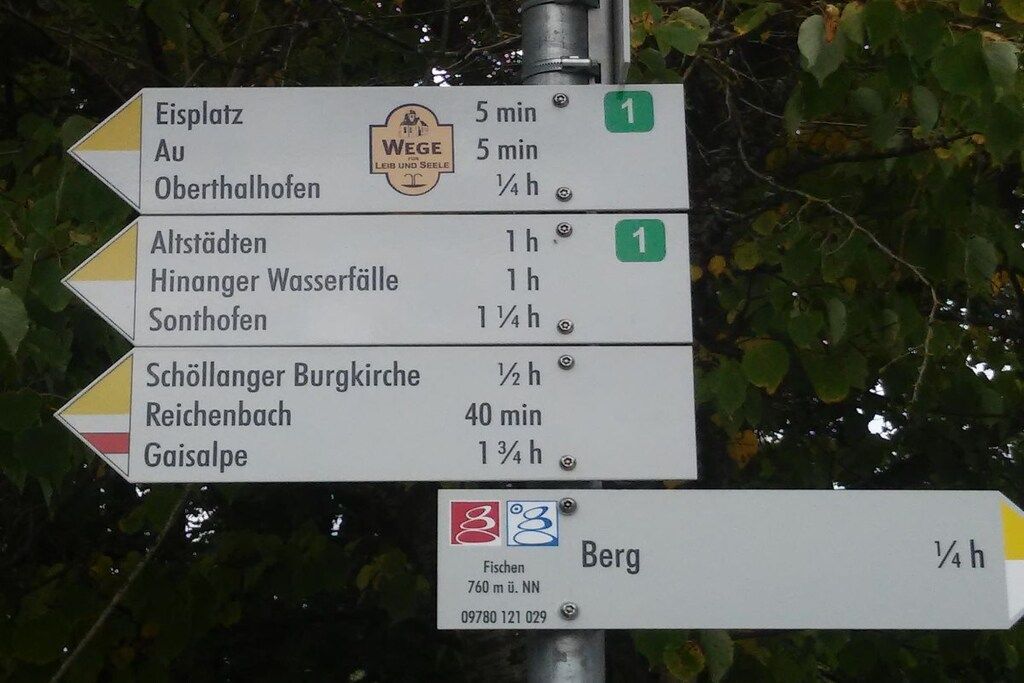 A directional sign with multiple destinations and estimated travel times.