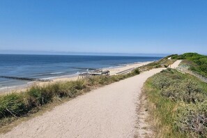A coastal path leading to a beach with a wooden walkway and a jetty. - Bungalow with 1 bedroom (Westkapelle)