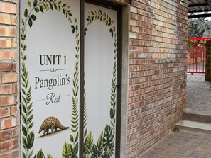 A brick building with a sign that reads 'UNIT 1 Pangolin's Rest.' - Pangolin's Rest - Unit 1 (Phalaborwa)