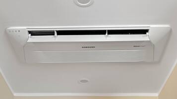 A Samsung air conditioning unit with a white exterior and a circular vent at the top.