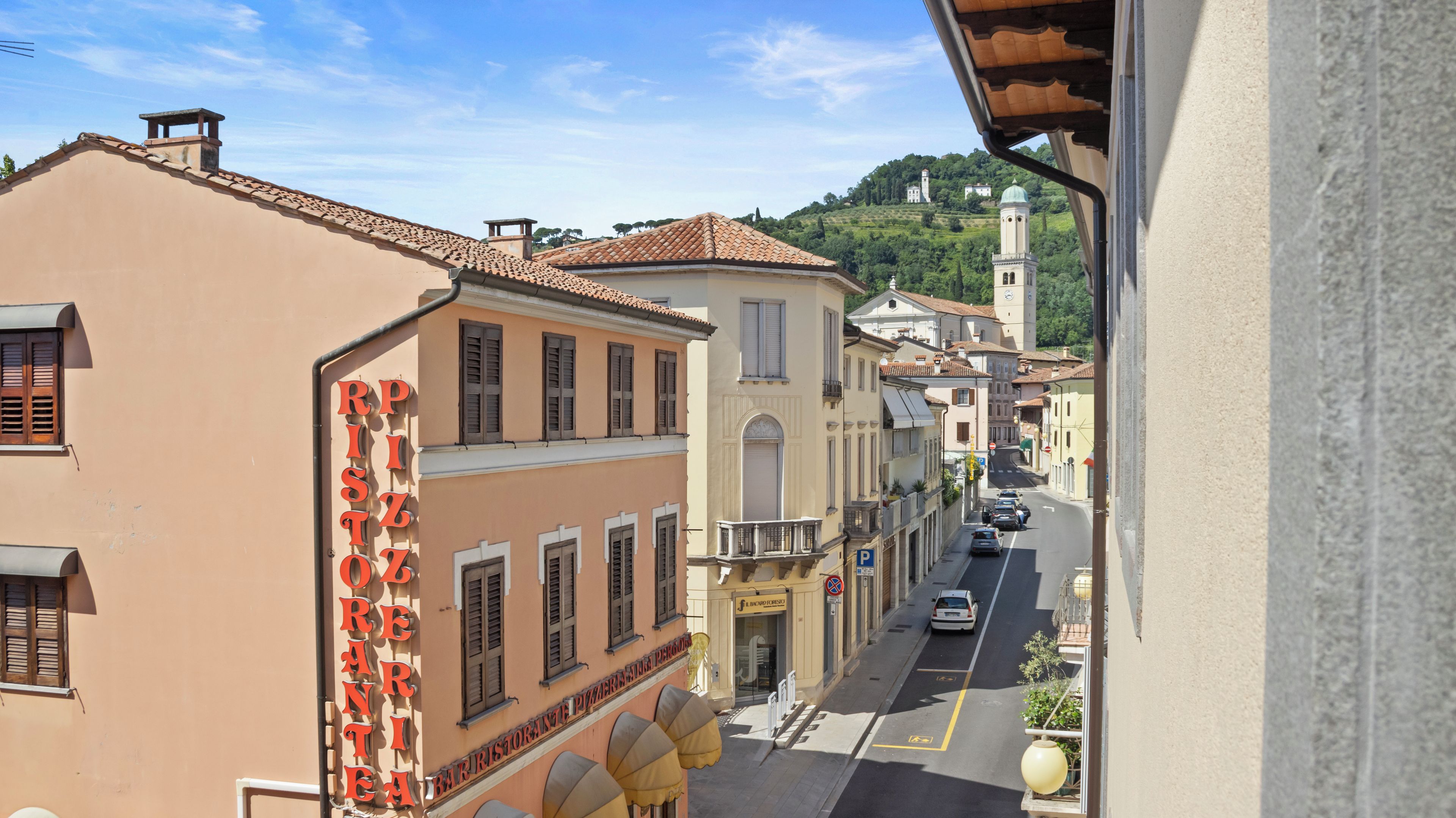 A street view with buildings, a restaurant sign, and a clear sky.