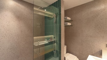 Un baño moderno con ducha de vidrio, lavamanos e inodoro.
