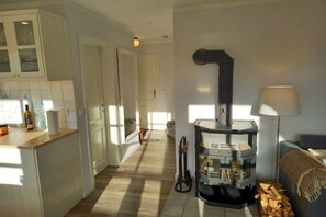 A kitchen with white cabinets, a stove, and a lamp. - Holiday apartment in Nieblum with balcony (Nieblum)