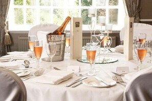 A table set for a meal with wine glasses, a bottle of champagne, and a menu. - Keavil House Hotel Dunfermline by Sunday - Executive family room (Dunfermline)