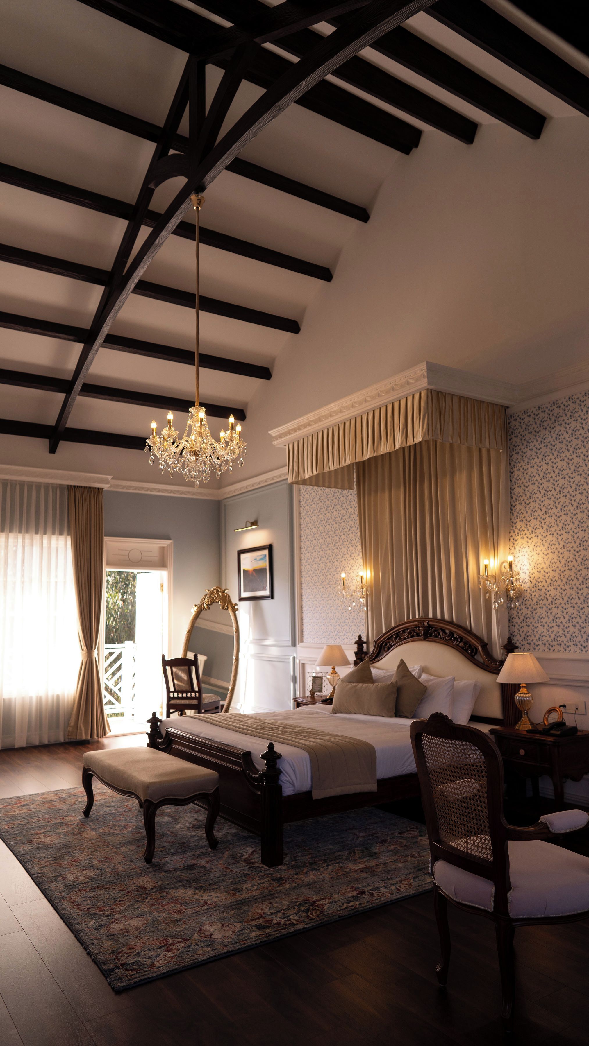 A bedroom with a large bed, a chandelier, and a view of the outdoors.