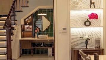 A modern interior with a staircase, a kitchen area, and a dining space.