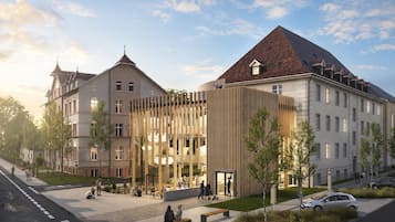 A modern building with a mix of traditional and contemporary architecture, featuring a prominent wooden facade and a classic pitched roof.