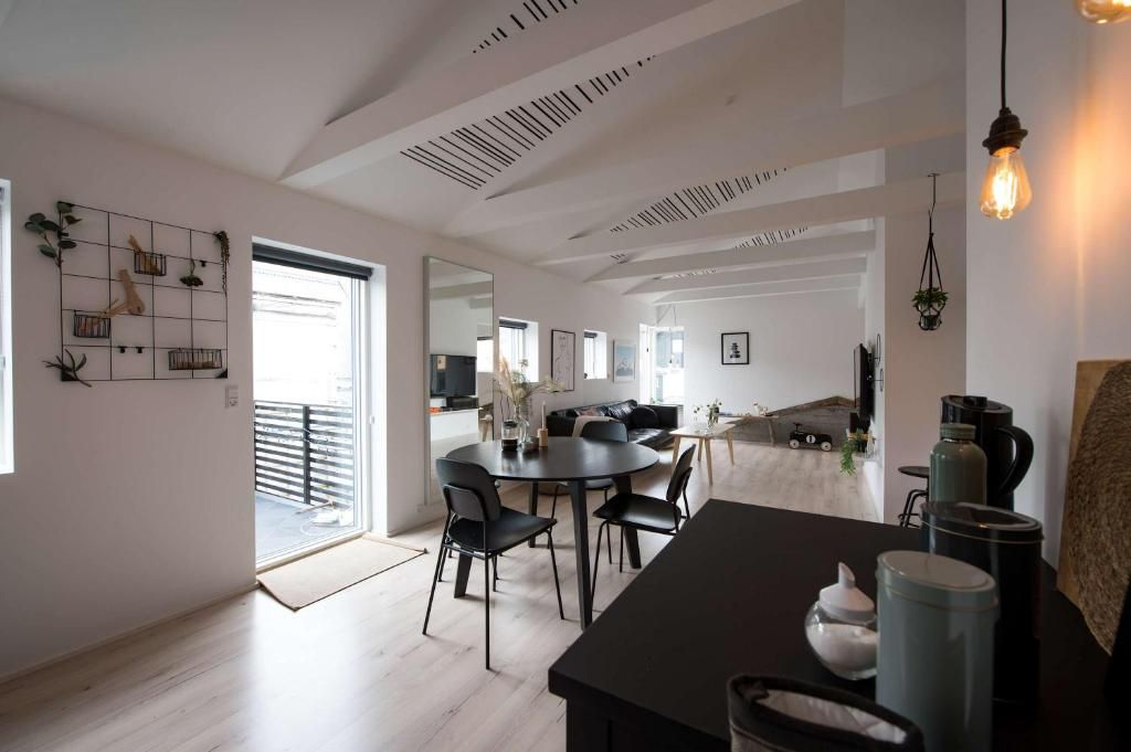 A modern interior with a dining area, kitchen, and living space.