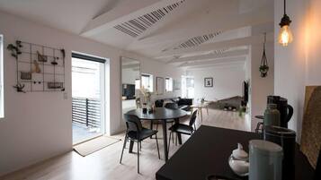 A modern interior with a dining area, kitchen, and living space.