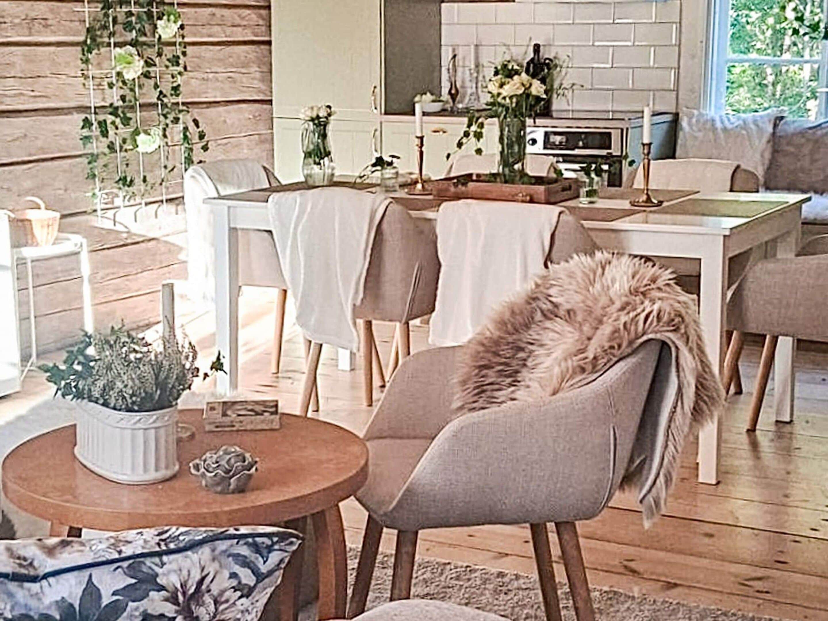 A cozy living room with a fireplace, a dining table, and a comfortable seating area.
