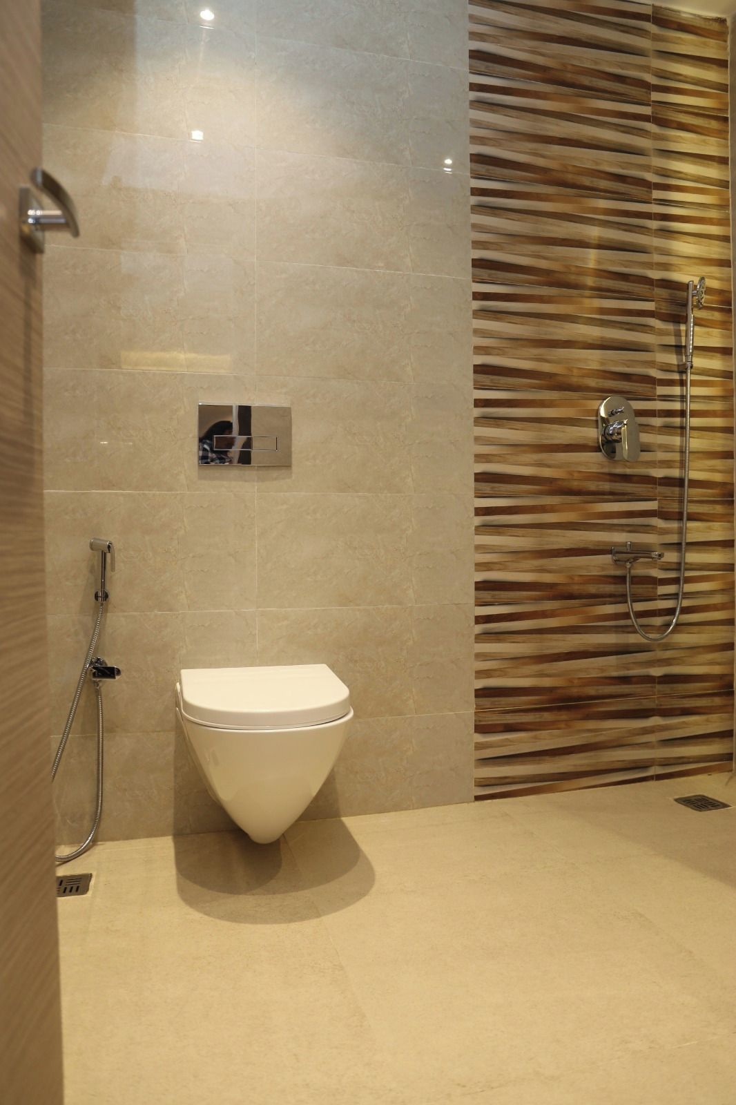 A modern bathroom with a toilet, shower, and a wall with a wood-like pattern.
