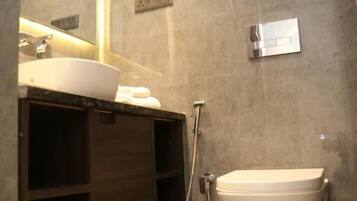 A modern bathroom with a vanity, sink, and toilet.