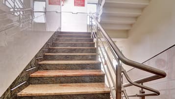 A staircase with metal railings and granite steps leading upwards.