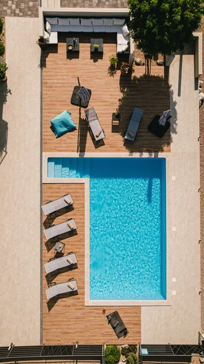 A rooftop pool area with sun loungers, a small seating area, and a pool. - Villa B4 in Ibenik (Sibenik)