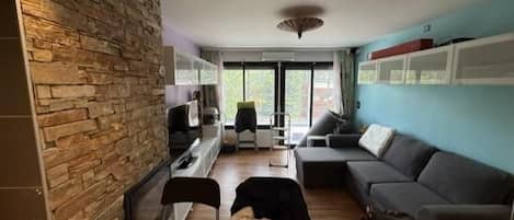 A compact living space with a kitchenette, a dining area, and a seating area.